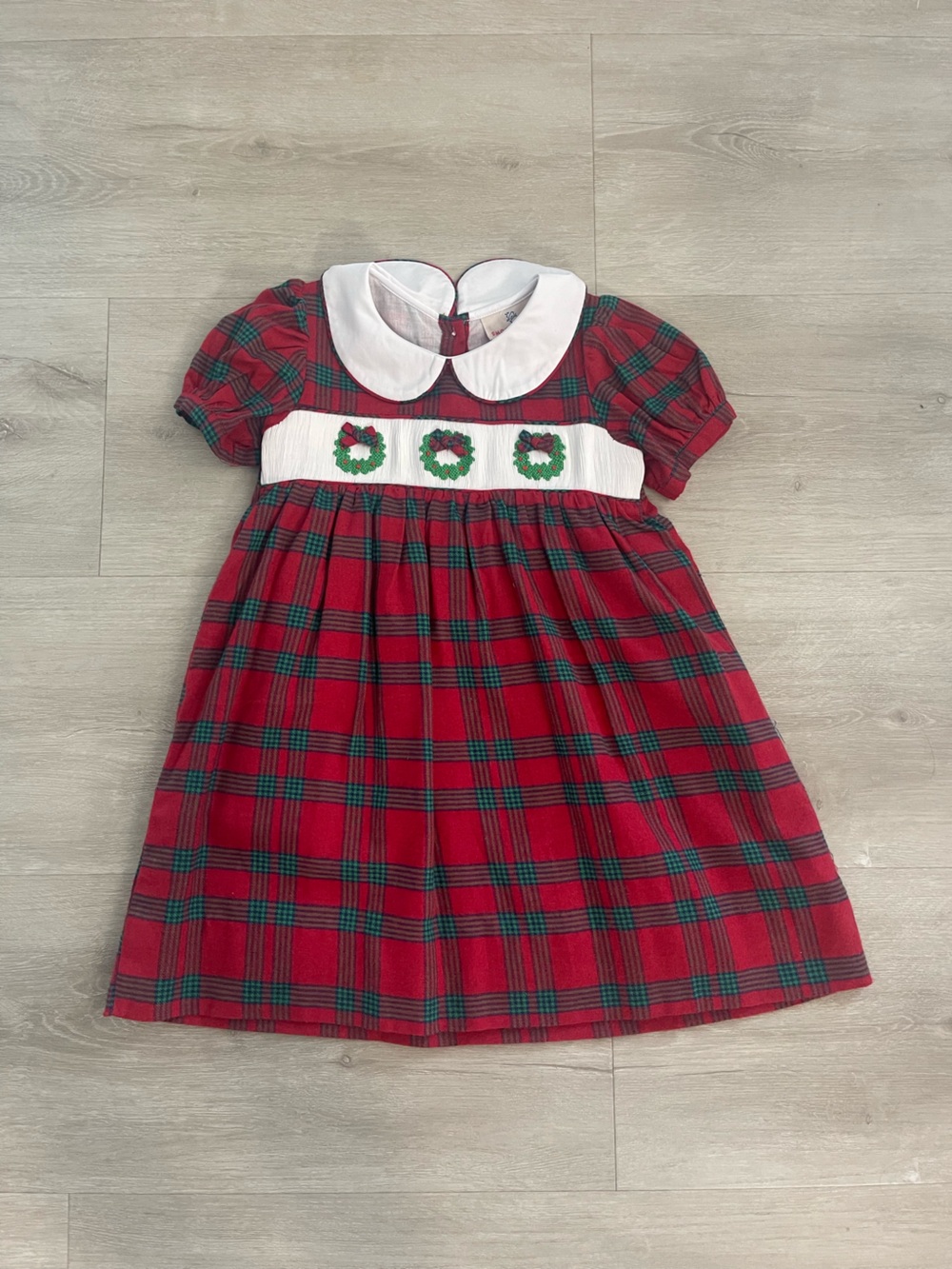 Red Plaid Holiday Dress with White Collar and Wreath Trim